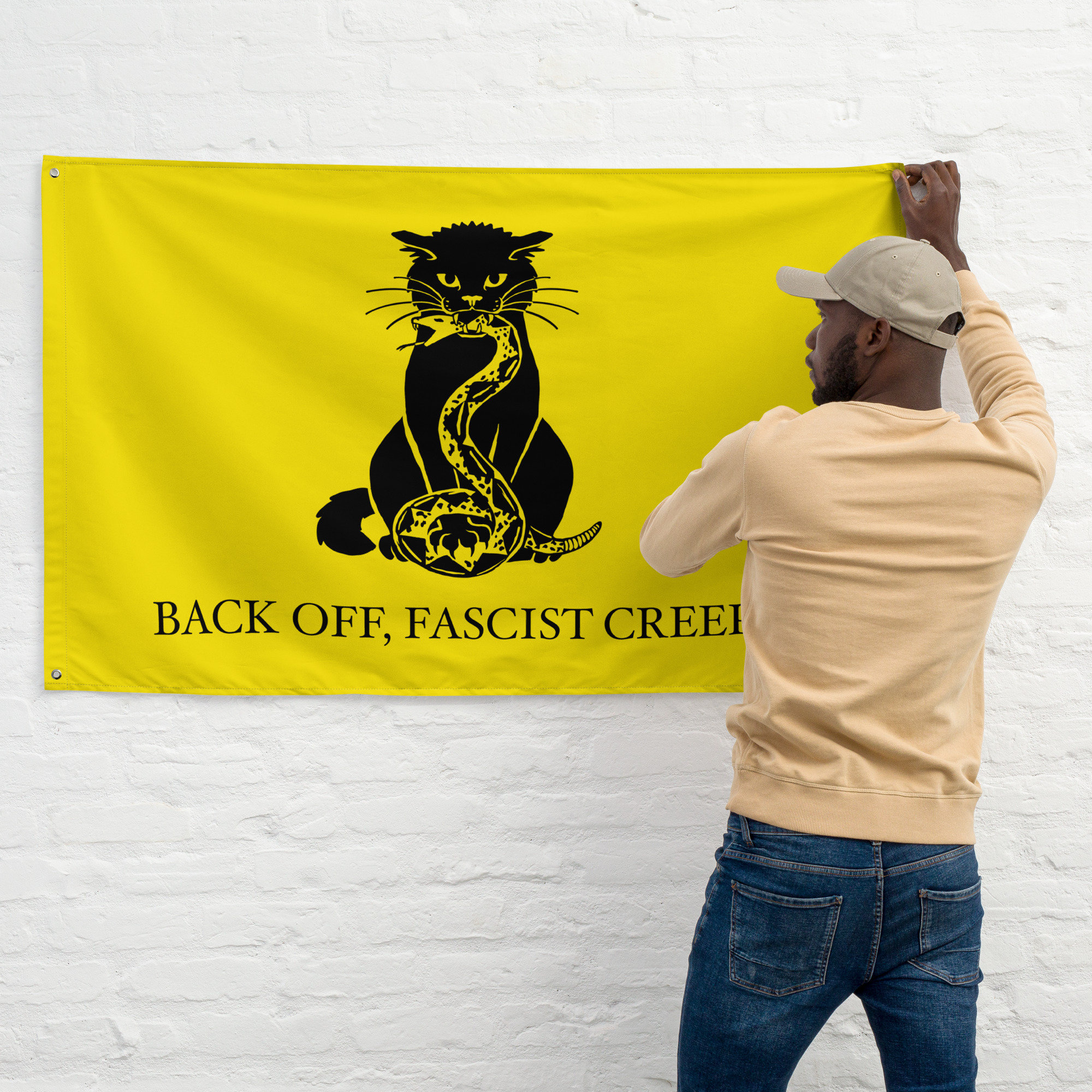 A man hanging up the flag on a wall