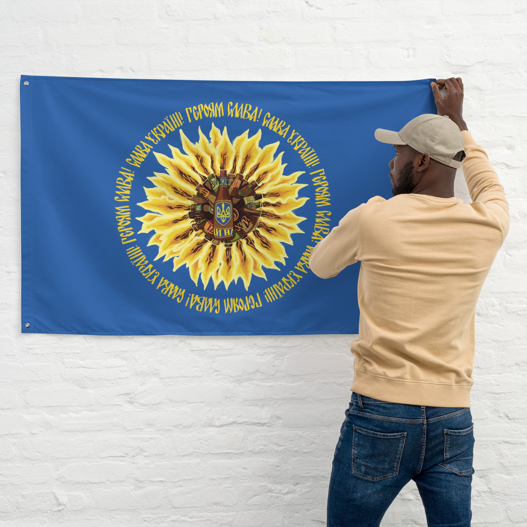 A person hangs the flag horizontally on a wall.