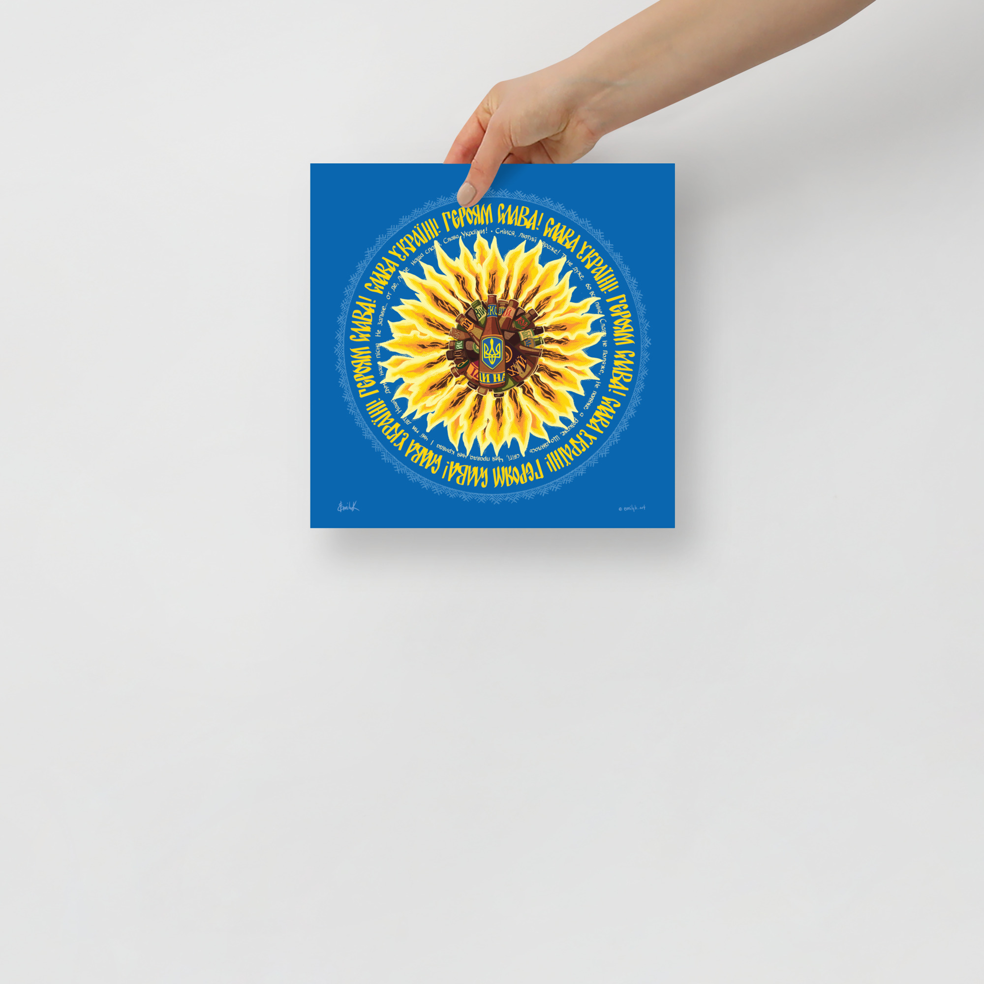 A hand holds a copy of the molotov sunflower print.