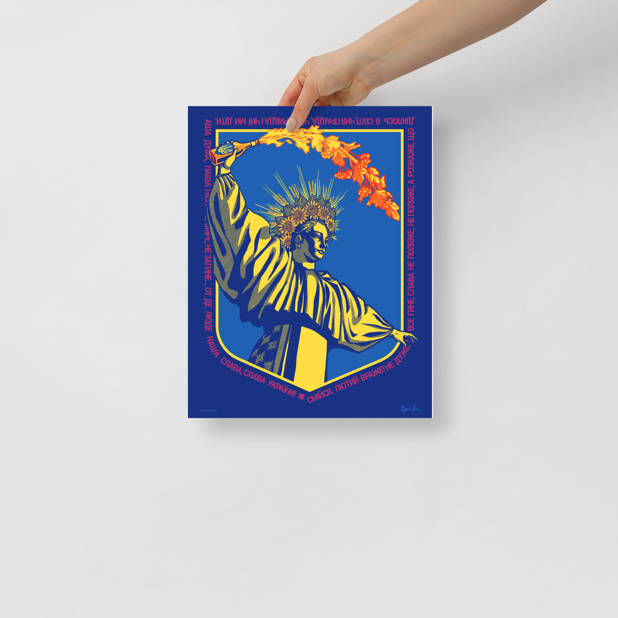 A hand holds the 11 inch by 14 inch print.