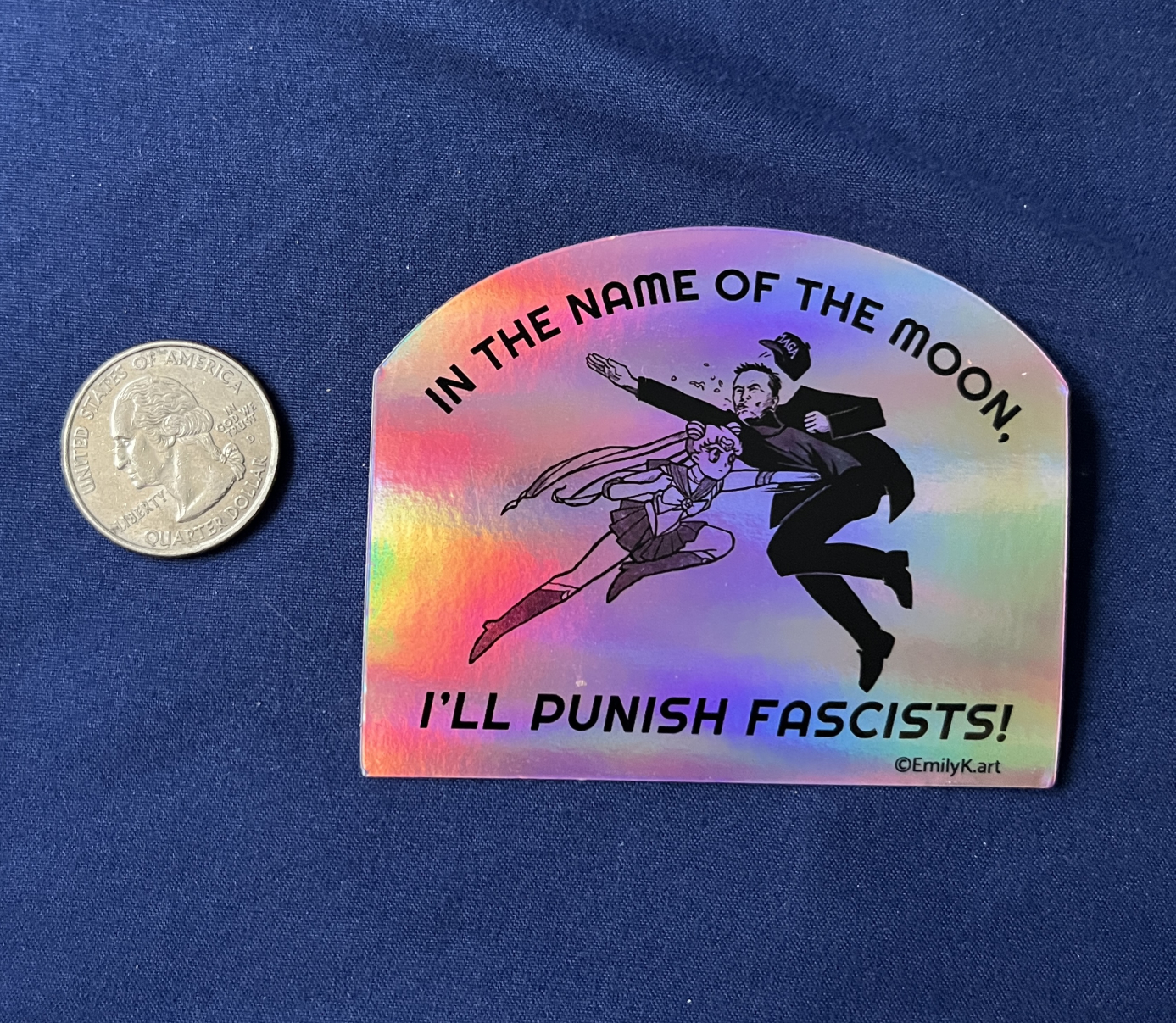 Sailor Moon Punching Elon sticker next to a quarter coin for scale.