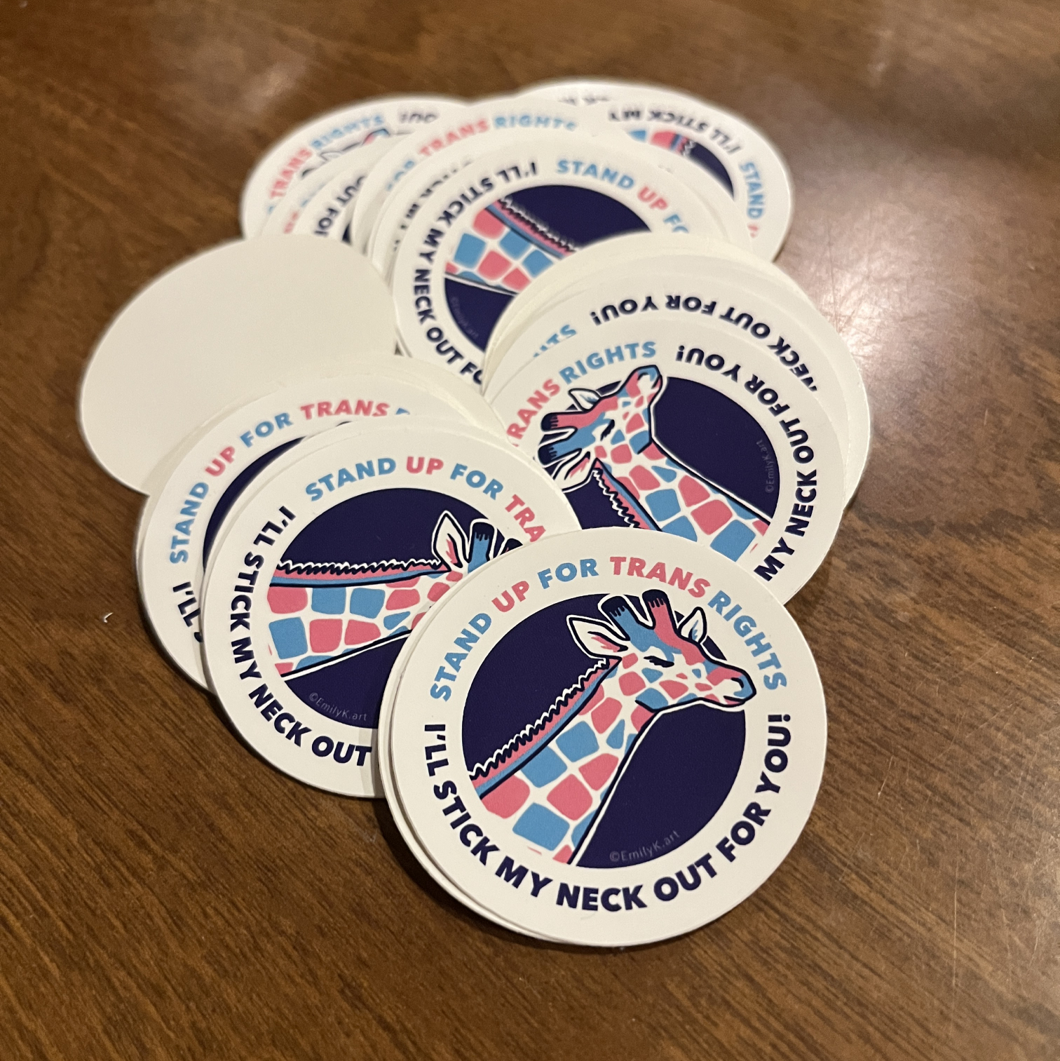 A pile of trans rights giraffe stickers.