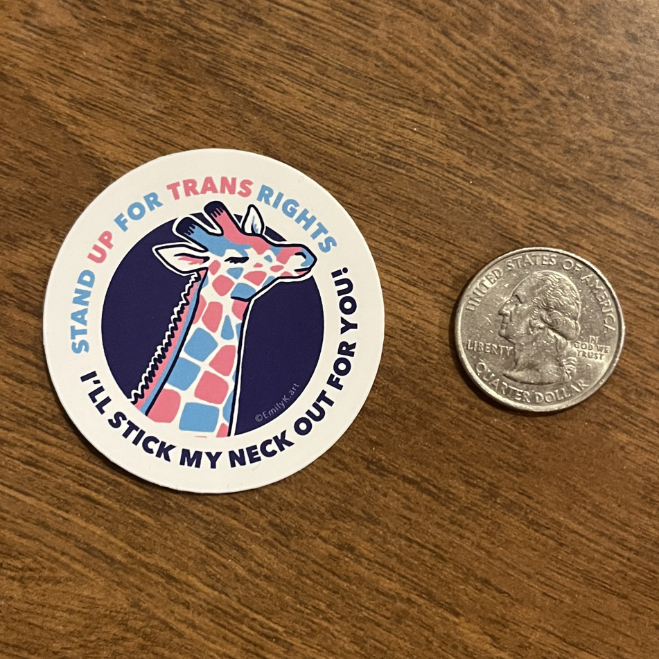 trans rights defender giraffe sticker, sitting next to a U.S. quarter coin for size.