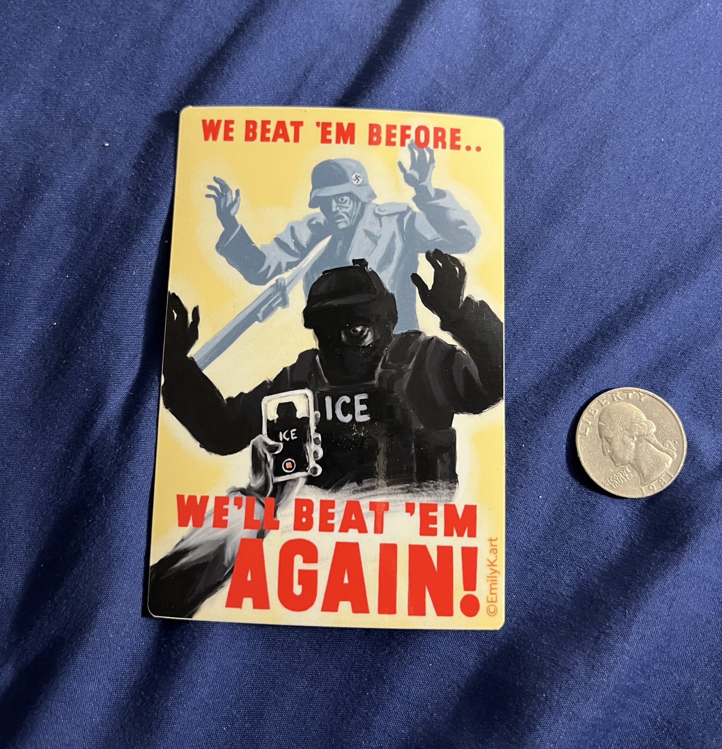 A vinyl sticker next to a quarter for scale. A shadowy figure - an ICE agent - lurks menacingly at someone off screen, as a hand holding a phone points to him, filming him. Above and behind him is a Nazi soldier in grey, being held at the point of a bayonet. It says in red text, "We Beat 'Em Once.. We'll Beat 'Em Again!"
